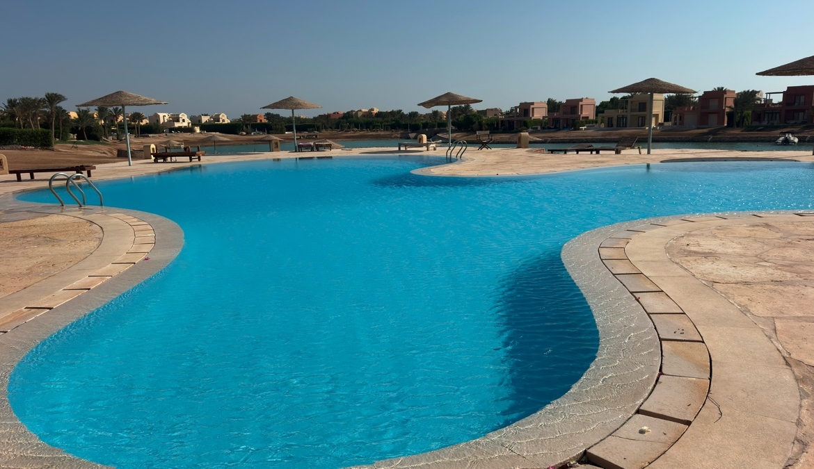 Lagoon and sunbeds outside West Golf apartment