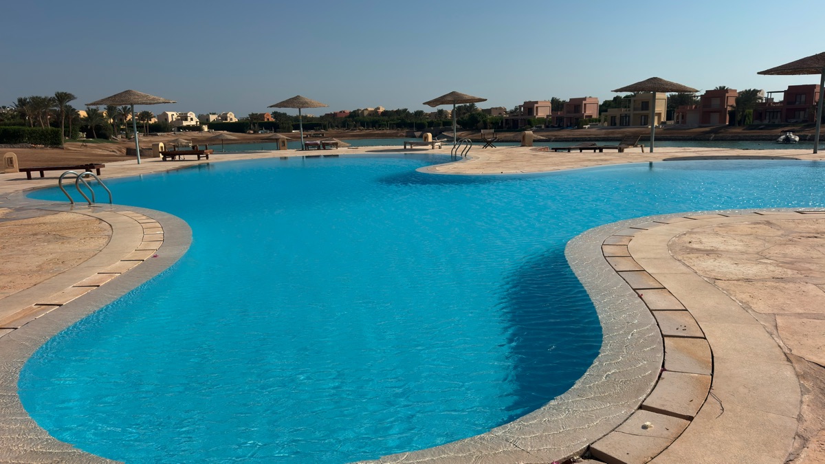 Lagoon and sunbeds outside West Golf apartment
